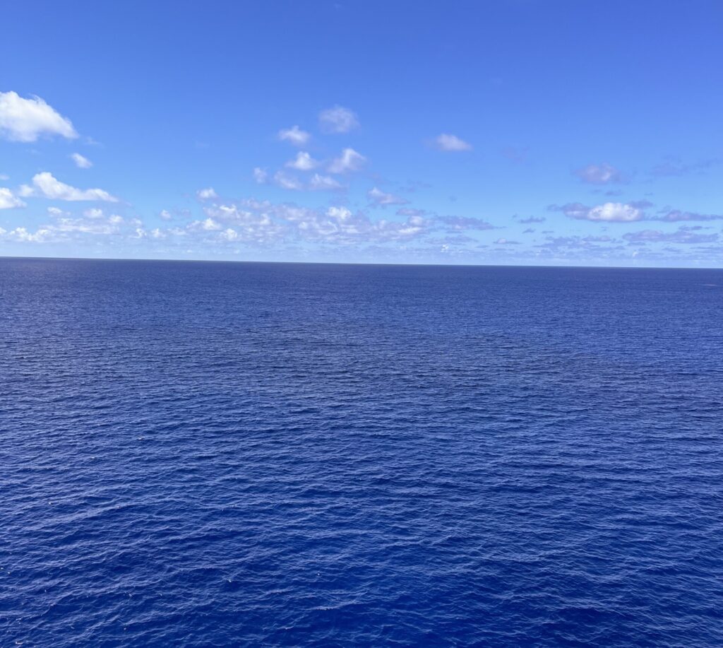 Open water meeting the horizon under a quiet sky.